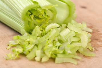 Fresh green celery on wooden board.