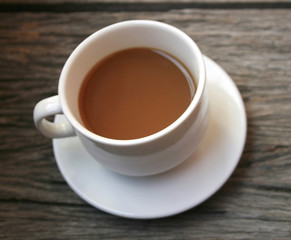 coffee in a white cup on wooden