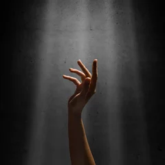 Fotobehang woman's hand reaches for the light rays © adam121