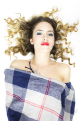 beautiful woman lying on white