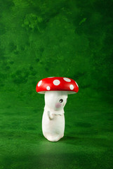cute puppets handmade, one mushrooms, green background