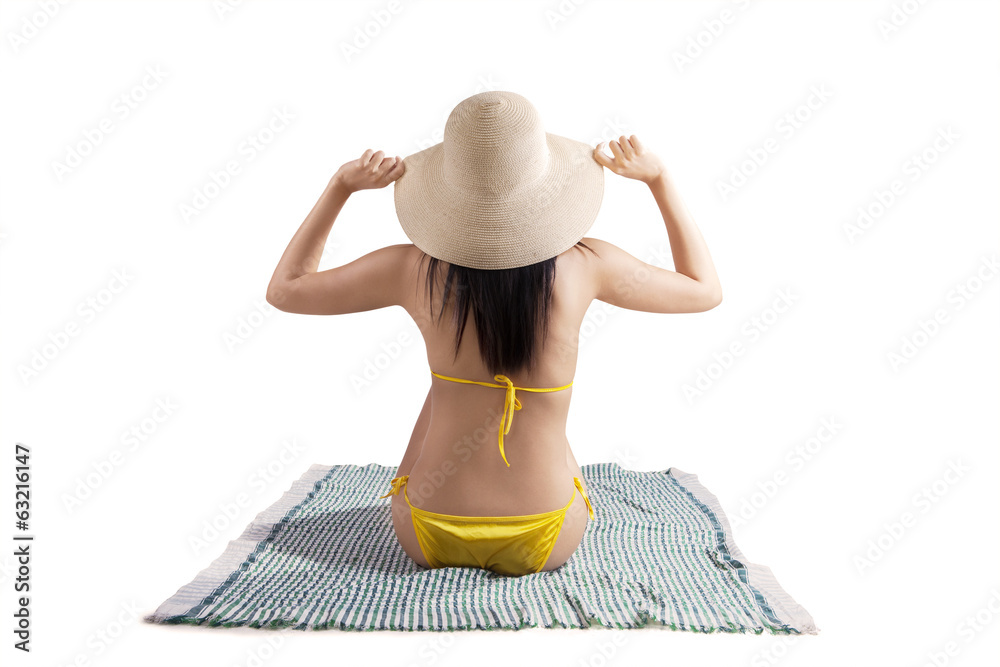 Wall mural sexy woman wearing bikini sitting on mat