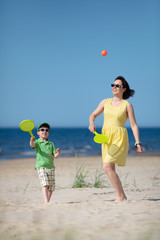Young mother and son playing on the beach - 63216186