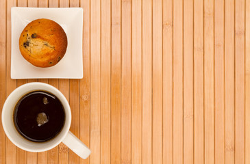 Vanilla with chocolate chips Muffin with a cup of coffee