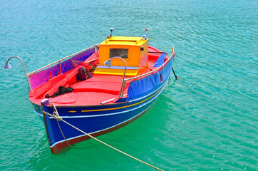 Traditional greek fishing boat painted in bright colors - 63218381