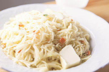 Macaroni With Piece of Butter On White Plate