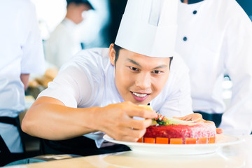 Asian chefs cooking in Restaurant