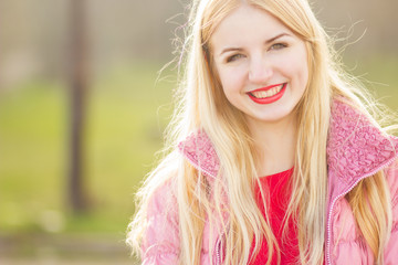 Naklejka premium portrait of blond woman in red maxi dress