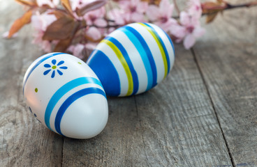 Colored Easter eggs and cherry blossom flowers