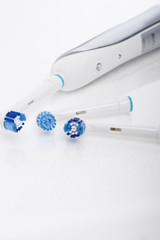 Modern Electric Toothbrush with a Few Spare Heads Together