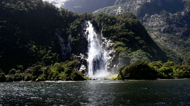 Spectacular waterfall in Milford Sound fiord, New Zealand.