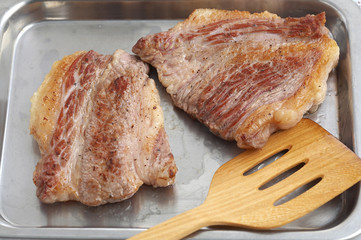 beef grill and wooden spoon in natural light