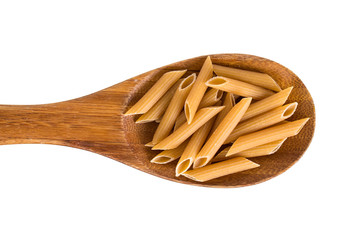 Wholemeal penne pasta on a wooden spoon