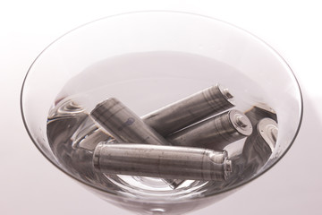 isolated of old AA battery in wine glass is energy consumption c