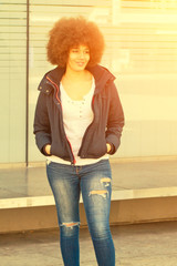 Young woman with afro hair cut in the sun