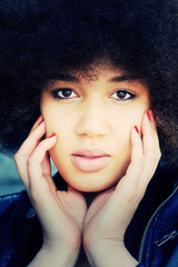 Beautiful face of a young black woman with afro hair cut