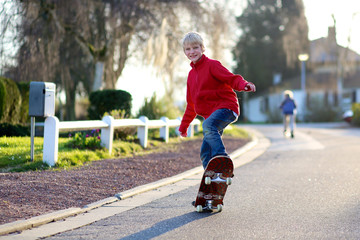 Happy boy having fun with skate board on the street