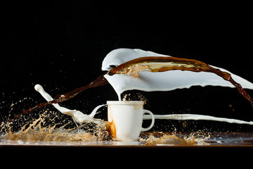 Coffee and milk pouring in a cup