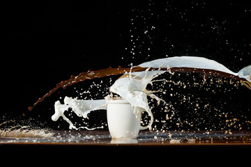 Coffee and milk pouring in a cup
