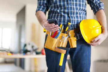 Close up of construction worker with mobile phone