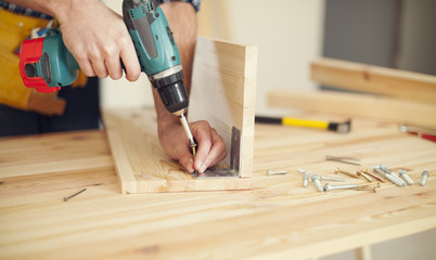 Close up of carpenter working with drill - Powered by Adobe