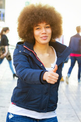 Young black woman with thumb up