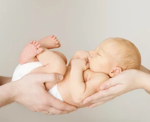 Fototapeten baby newborn sleeping on parents hands, kid and family concept © inarik