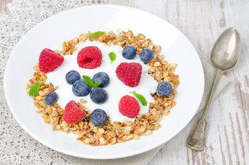 homemade granola with yogurt, raspberries and blueberries