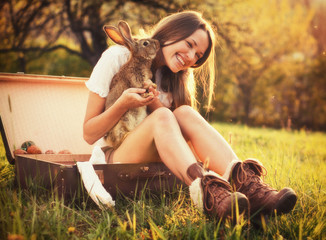 Vintage style photo from a beautiful young woman with her bunny