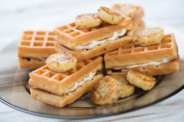 Waffles with slices of grilled banana, close-up, studio shot