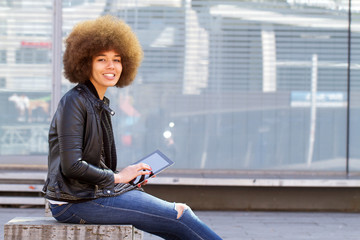 Modern girl with a tablet in the city