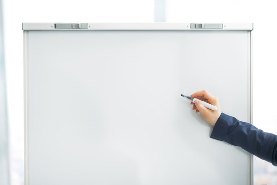 Closeup On Business Woman Writing On Flipchart