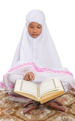 Young Muslim Girl In White Hijab Reading Al Quran