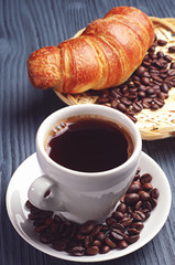 Coffee cup with a croissant
