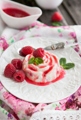 Delicious dessert with raspberry sauce and fresh berries