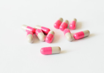 Pink gray capsules of medicine.