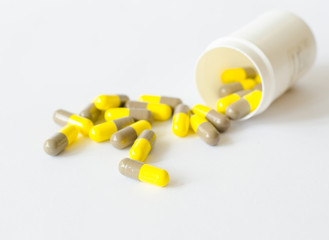 Yellow gray capsule and bottle.
