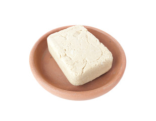 Halva with peanuts in bowl of clay isolated over white
