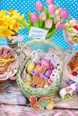 easter basket with eggs,gingerbread bunny and fresh tulips