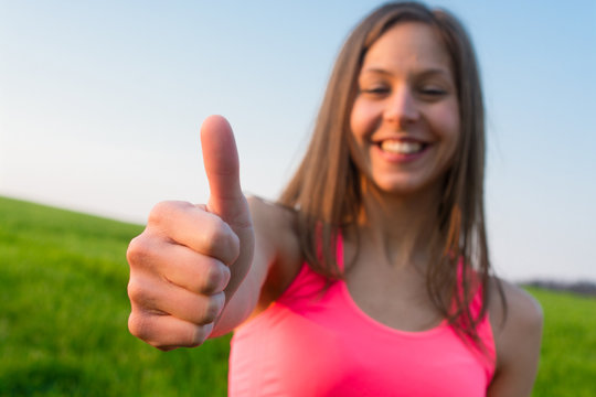 Happy Young Woman Showing Thumb Up