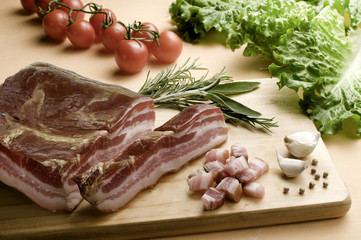 bacon, slices and dice, on wooden table