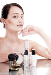 Obraz na płótnie Canvas Woman with a good complexion near the creams cosmetics.