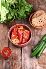Baked red peppers with meat and rice.Black bread,vegetables and
