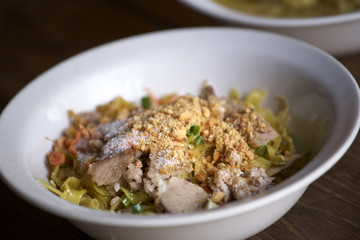 sweet thai yellow pork noodle on wood table