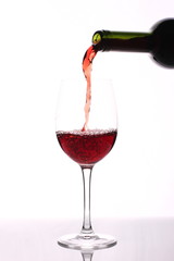 Pouring red wine into wine glass