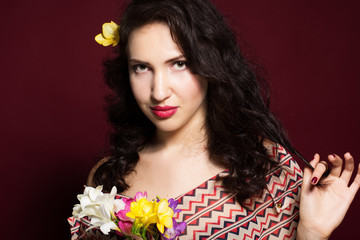 Fototapeta premium Pretty brunette lady with fresia flowers
