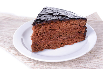 Delicious chocolate cake on plate on table close-up