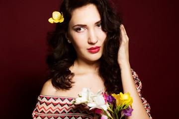Fototapeta premium Pretty brunette lady with fresia flowers