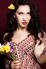 Fototapeta premium Pretty brunette lady with fresia flowers