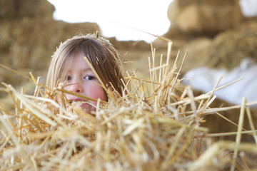 Little girl hiding in the hay © mimagephotos